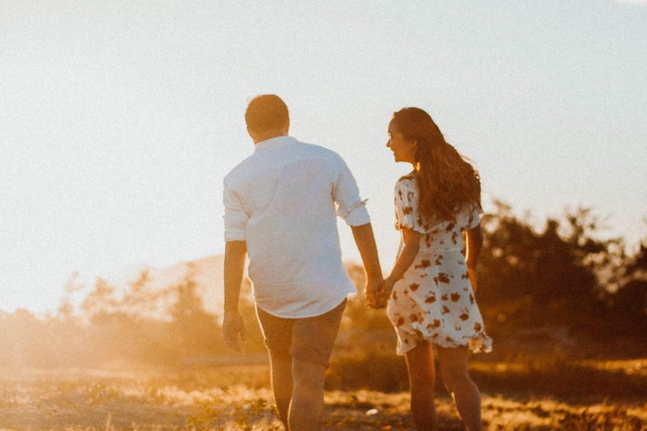 couple-walking-on-grass-field-3341831